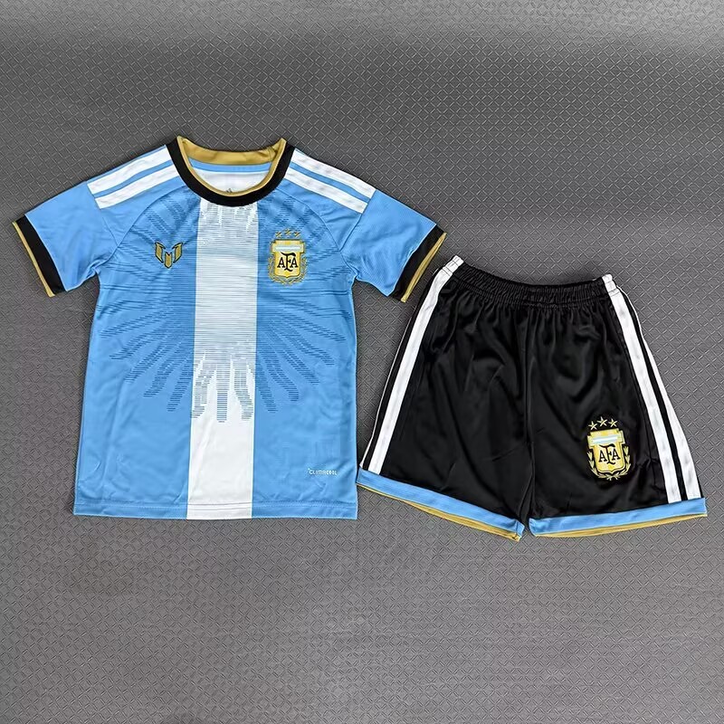 Argentina children’s sky-blue and white shirt beside black shorts, front view